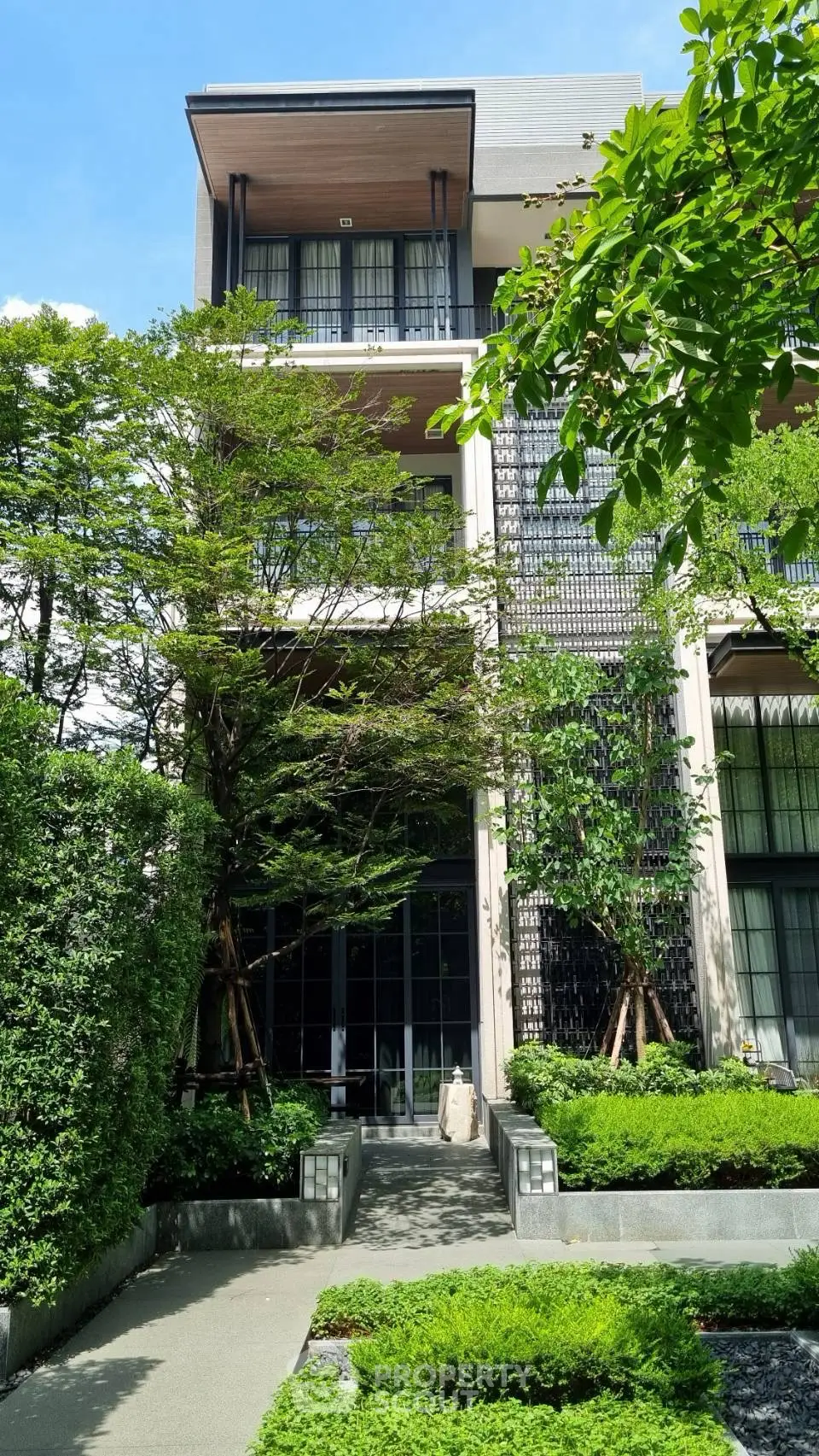 Modern residential building with lush greenery and contemporary design