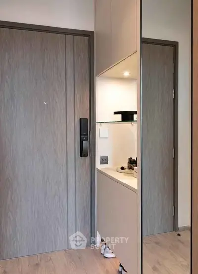 Modern apartment entrance with sleek wooden door and built-in storage