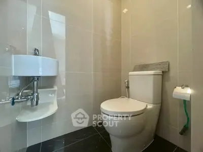 Modern bathroom with sleek fixtures and glossy tiles, perfect for a contemporary home.