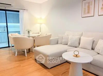 Elegant living room with modern furniture and open layout, featuring a cozy sectional sofa and stylish decor.
