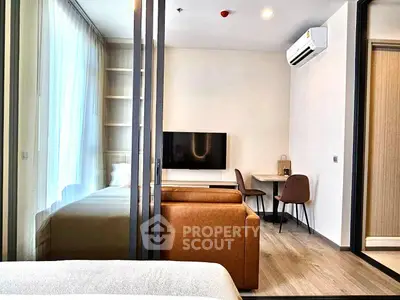 Modern studio apartment with cozy living area and sleek design