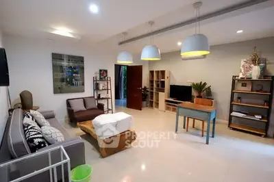 Spacious modern living room with stylish decor and ample natural light.