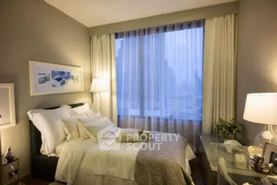 Luxurious bedroom with city view, elegant decor, and ambient lighting