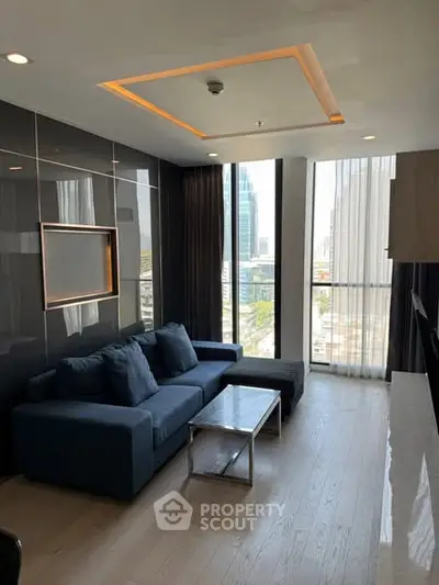 Modern living room with city view, featuring sleek design and comfortable seating.