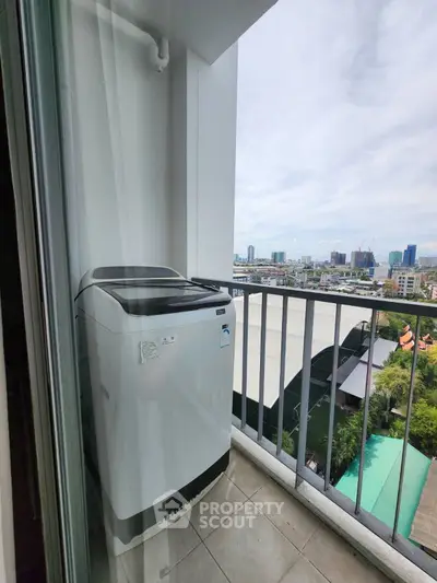 High-rise balcony with washing machine and city view, perfect for urban living.