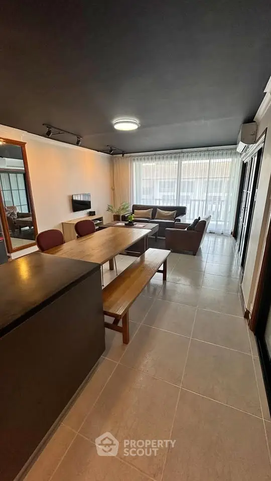 Spacious modern living room with stylish furniture and large windows