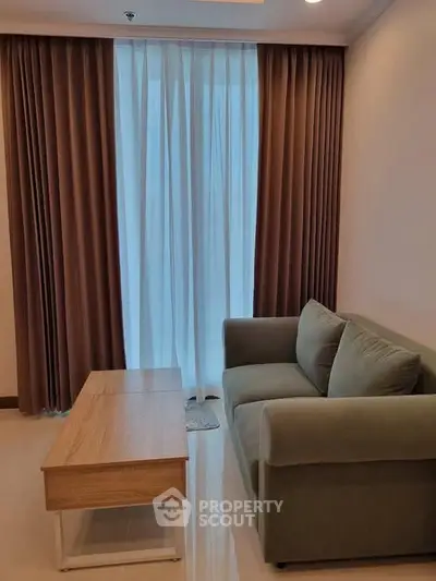 Cozy living room with modern sofa and elegant curtains, perfect for relaxation.