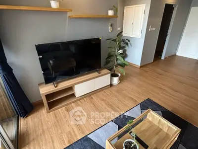 Modern living room with wooden flooring, TV unit, and stylish decor in a cozy apartment.