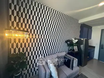 Modern living room with geometric accent wall and cozy seating area