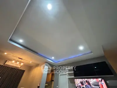 Modern living room with recessed lighting and sleek TV setup