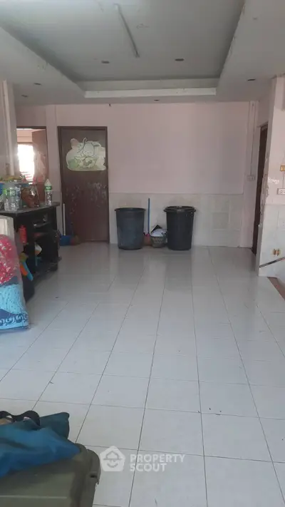 Spacious tiled room with potential for customization and storage solutions.