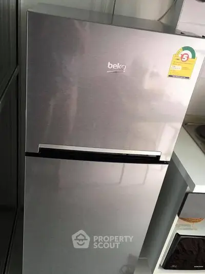 Modern stainless steel refrigerator in a sleek kitchen setting.