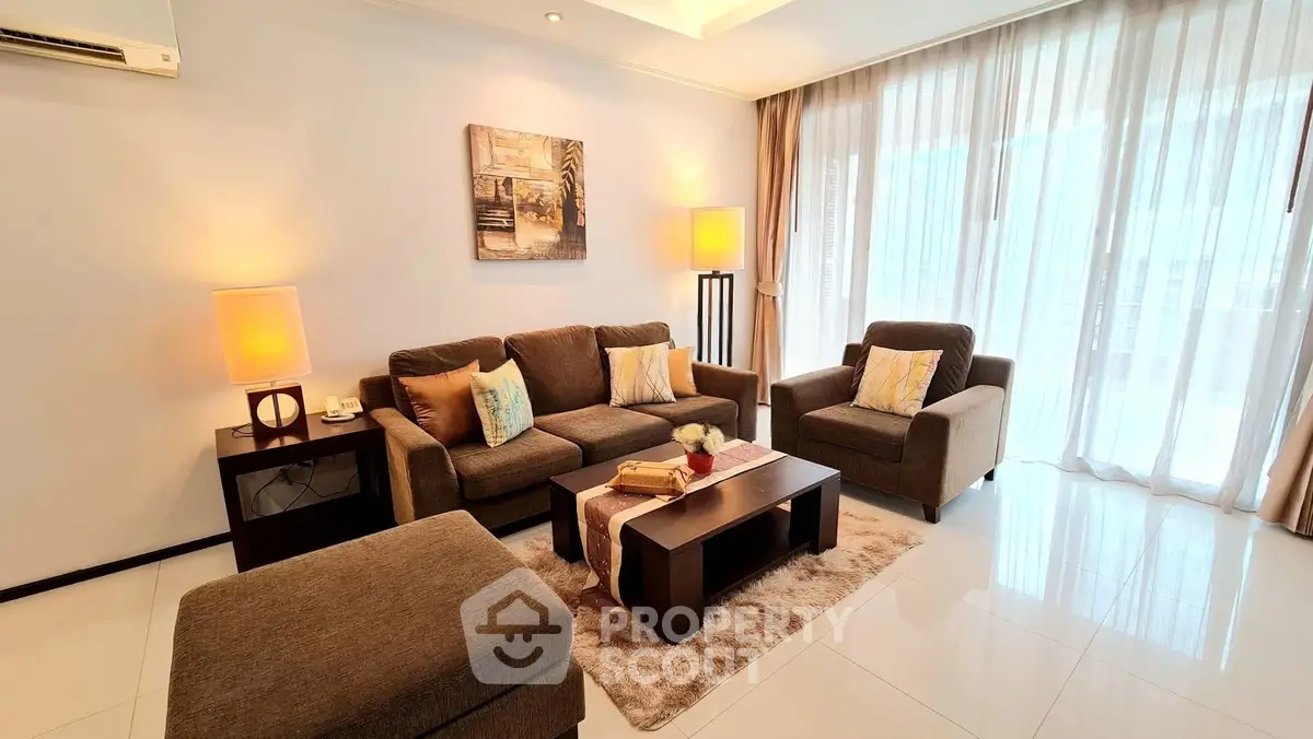 Elegant living room with modern furniture and large windows offering natural light.