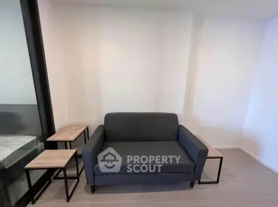 Modern living room with stylish sofa and side tables in a minimalist design.