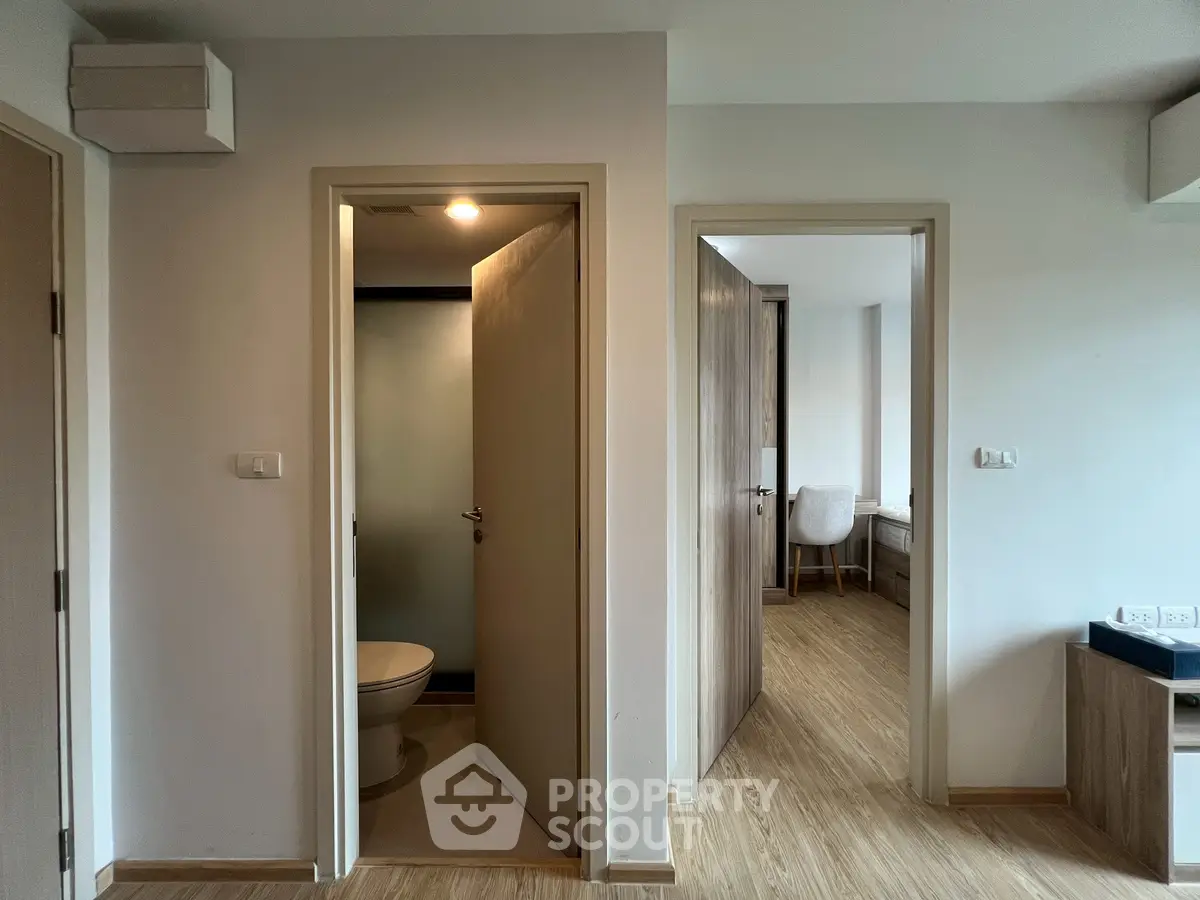 Modern apartment hallway with bathroom and study room access