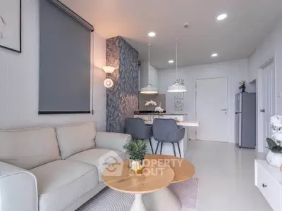 Modern living room with cozy sofa, stylish decor, and open kitchen layout in a contemporary apartment.