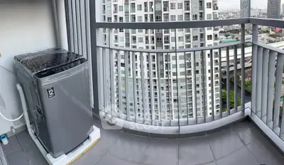 Modern balcony with city view and washing machine in high-rise apartment