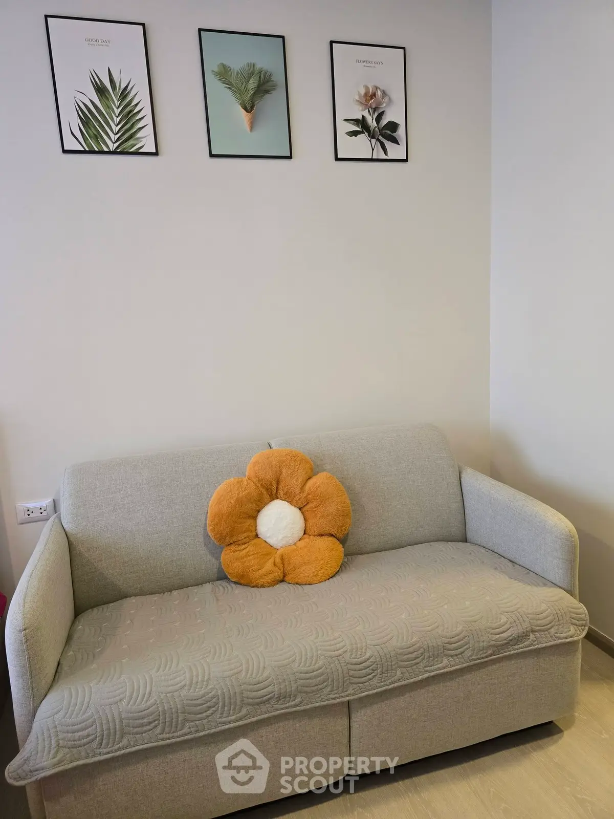 Cozy living room with stylish sofa and decorative wall art, perfect for relaxation.