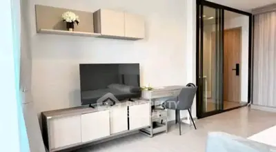 Modern living room with sleek TV stand and stylish decor in a contemporary apartment.
