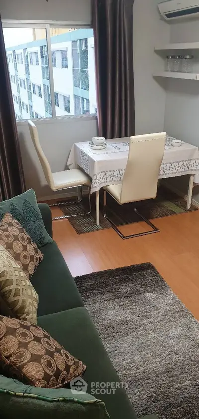 Cozy living room with dining area, featuring elegant decor and natural light.