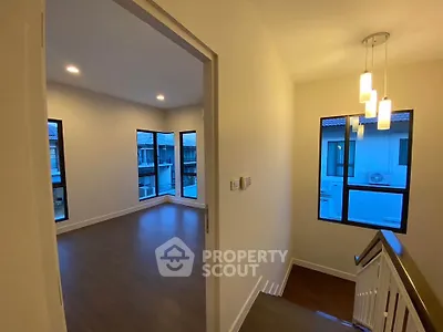 Spacious modern interior with wooden flooring and stylish lighting, perfect for a cozy home.