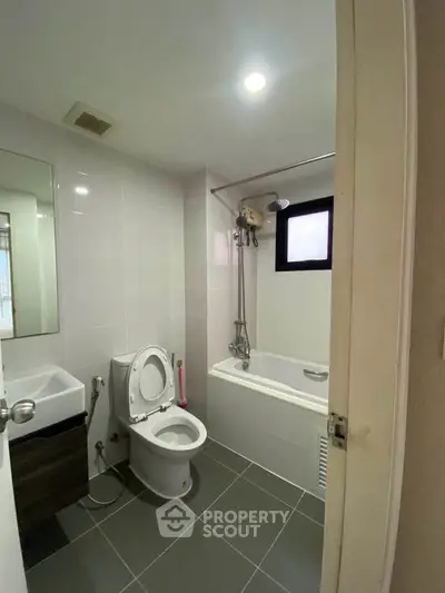 Modern bathroom with bathtub and sleek fixtures in a contemporary apartment.