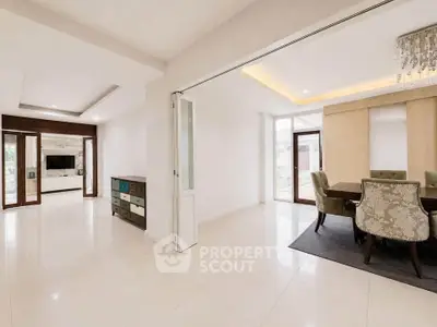 Spacious open-plan living and dining area with elegant decor and natural light.