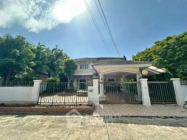 Charming suburban house with spacious driveway and lush greenery, perfect for family living.