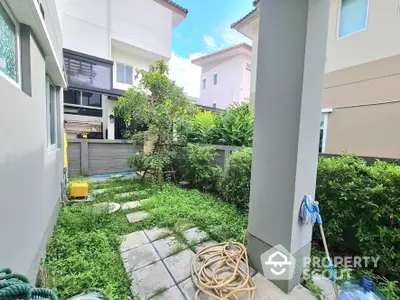 Charming garden view of modern suburban home with lush greenery and cozy outdoor space.