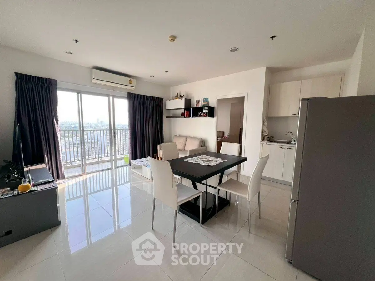 Modern open-layout living room with dining area and balcony view