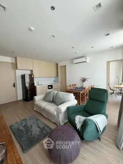 Spacious modern living room with open kitchen and stylish furniture in a contemporary apartment.