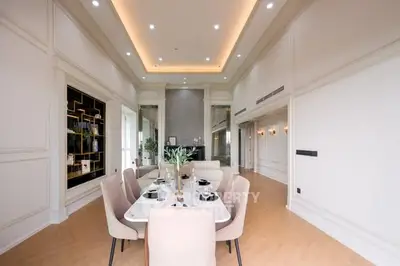 Luxurious dining area with elegant decor and high ceiling, perfect for entertaining guests.