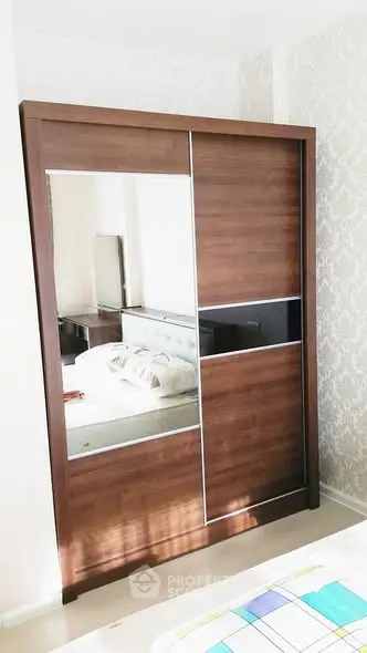 Modern bedroom with stylish wooden wardrobe and cozy bed