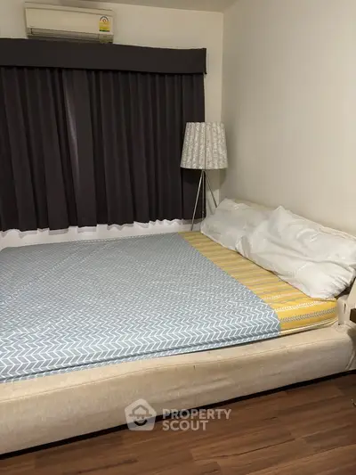 Cozy bedroom with modern decor and large bed in a stylish apartment.