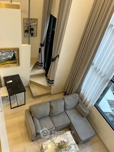 Modern loft-style living room with high ceilings and elegant decor