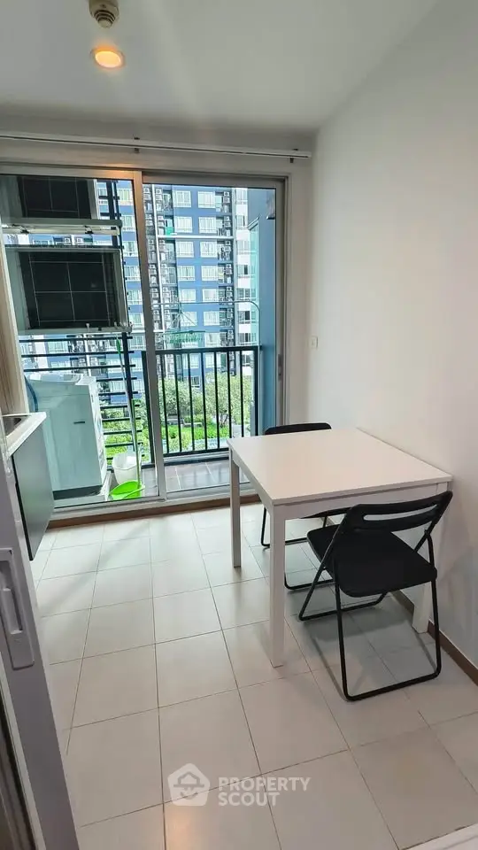 Modern kitchen with balcony view in high-rise apartment