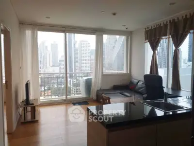 Modern living room with city view, open layout, and sleek furnishings in a high-rise apartment.