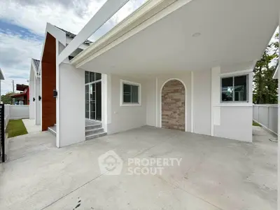 Modern single-story home with spacious driveway and elegant entrance