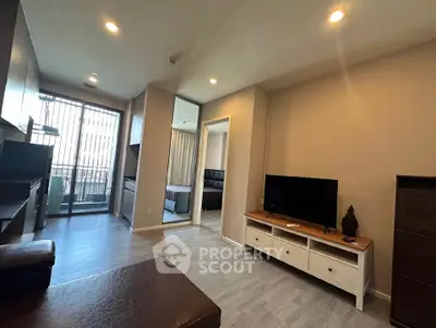 Modern living room with sleek design and balcony access in a stylish apartment.