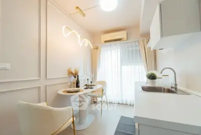 Modern kitchen with elegant dining area and stylish lighting