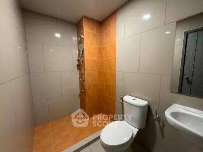 Modern bathroom with sleek tiles and walk-in shower design