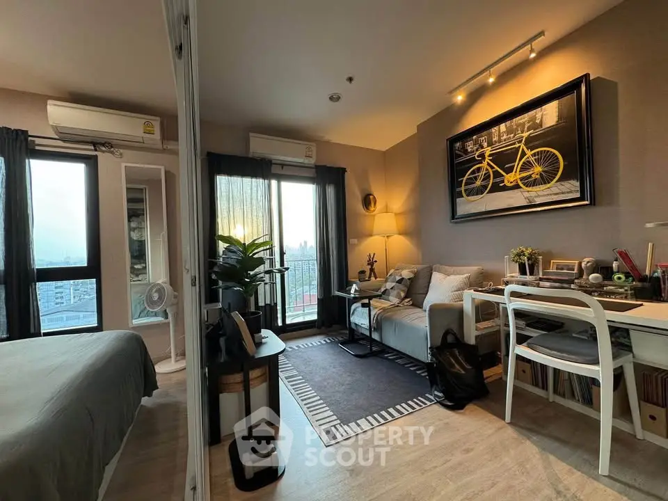 Modern living room with stylish decor and city view, featuring cozy seating and workspace.