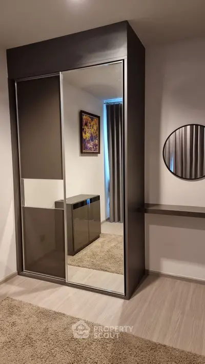 Modern bedroom with mirrored wardrobe and stylish decor
