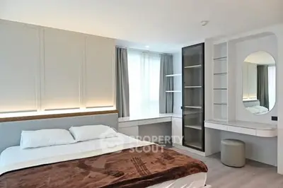 Modern bedroom with stylish decor and ample natural light
