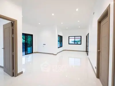 Spacious modern living room with large windows and elegant flooring