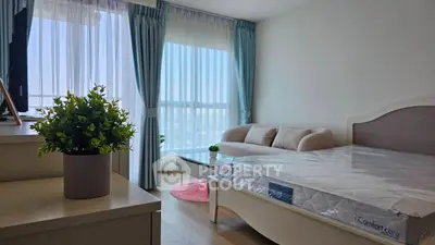 Bright and airy bedroom with large windows and modern furnishings in a stylish apartment.