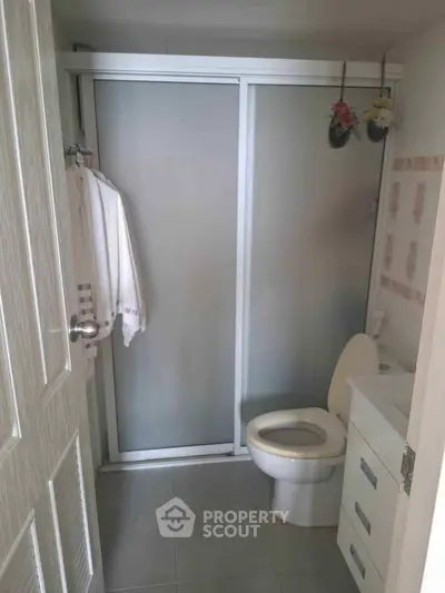 Compact bathroom with sliding shower door and modern fixtures
