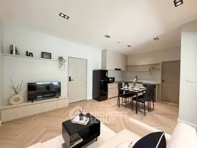 Modern open-plan living room and kitchen with sleek design and stylish decor.