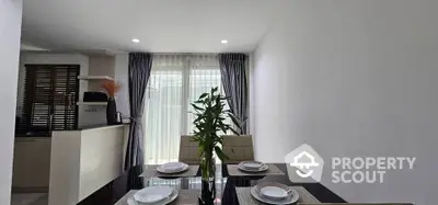 Modern dining area with elegant table setting and natural light