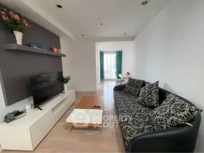 Spacious living room with modern decor and natural light, perfect for relaxation and entertainment.